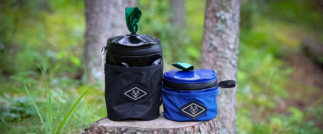 Dog waste holder attached to outdoor dog gear during a walk or hike