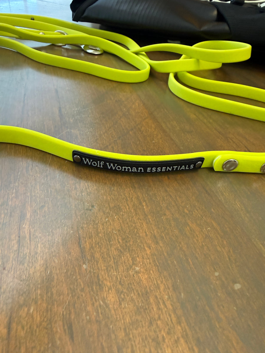 Eco Performance Leash in Lime coiled on a wood table, showing the Wolf Woman Essentials badge, shared by a customer